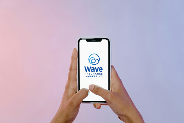 Wave Marketing logo on a smartphone being held by a user