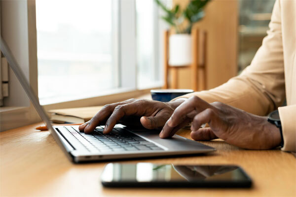 Image of a person researching on a laptop why some insurance websites struggle to perform in search results
