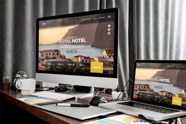 Image of a desktop computer and a laptop comparing WordPress vs other website builders for insurance company websites